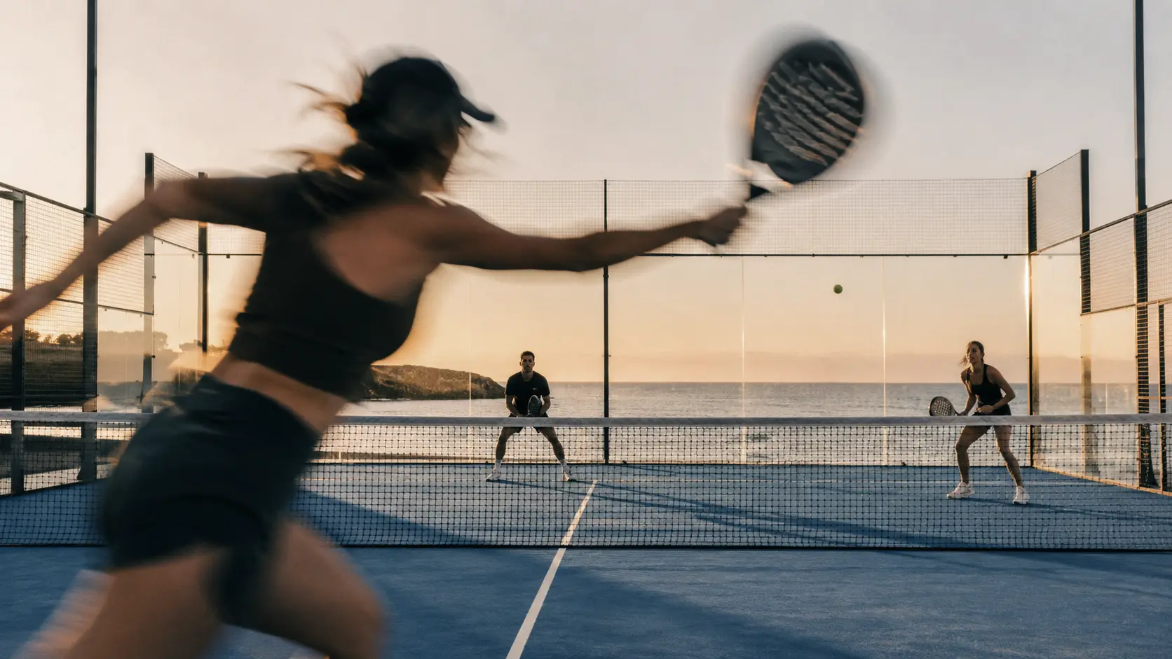A serve tossed against the sunset on Court No. 01, the sea holding the last of the colour
